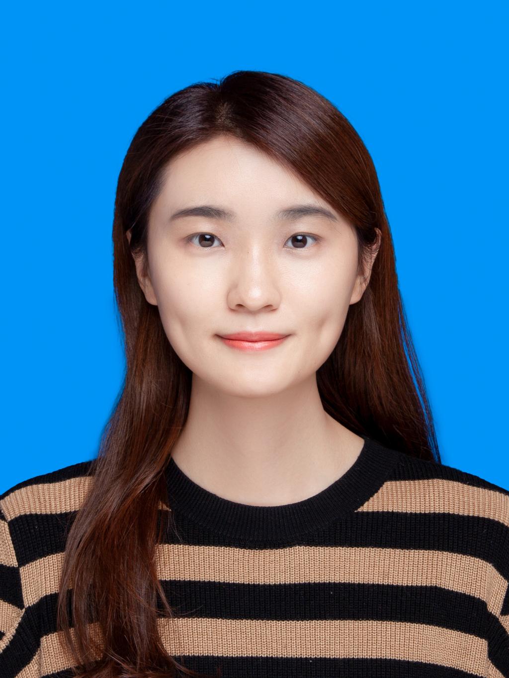 A person with long hair wearing a striped shirtDescription automatically generated